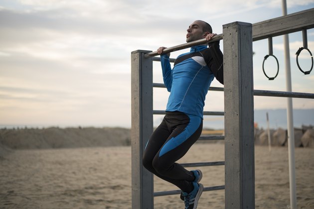 Doing chin-ups on the beach