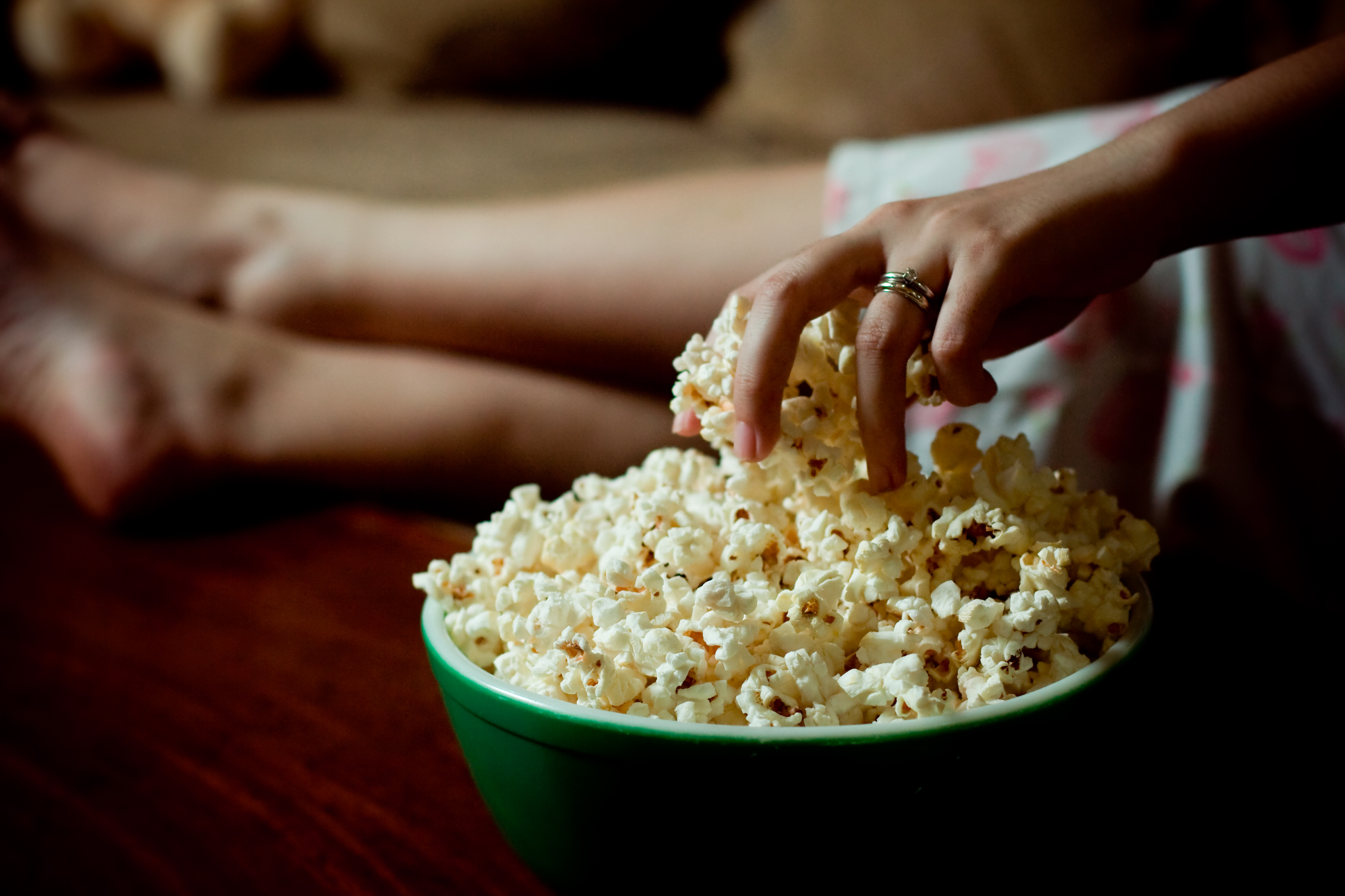 Woman with big thighs holding a larg bag of popcorn Stock Photo