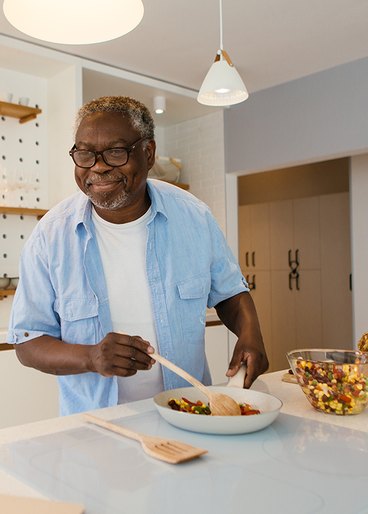 A man cooking a healthy meal in his kitchen