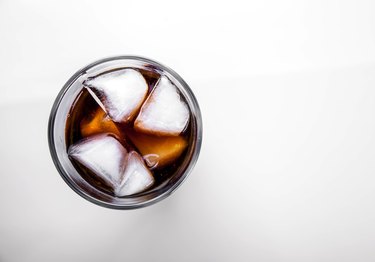 soft drinks. Cola glass with ice cubes on white background