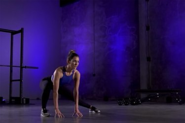 Woman demonstrating how to do the lateral squat stretch as part of a mobility workout