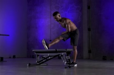 Woman demonstrating how to do the standing hurdlers stretch as part of a mobility workout