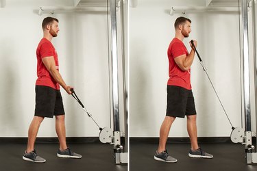 Man performing biceps curl on the cable machine