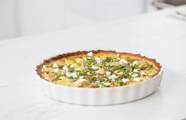Cauliflower quiche in pan on white table