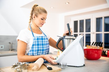 Woman using meal prep tools for baking in the kitchen