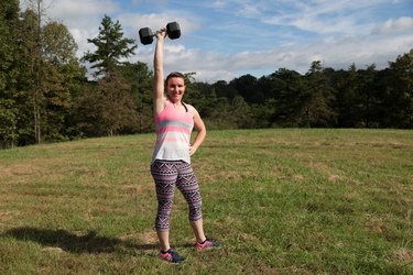 Brittany lifts a weight outside