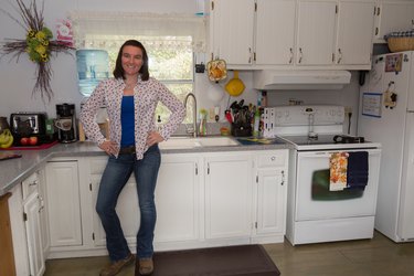 Brittany stands in her kitchen.