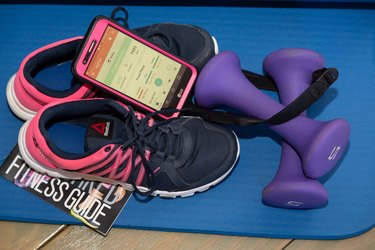 Brittany’s shoes, weights and phone showing the MyPlate app