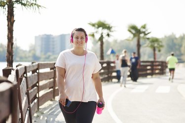 woman doing an interval walking workout along the beach