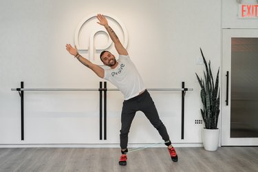 Man doing resistance band ab exercises at a fitness studio