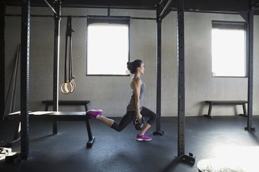 Woman performing Bulgarian split squat.