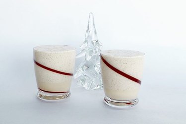 glasses of eggnog on white background