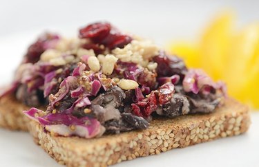 Close view of an open-faced sandwich with black beans and slaw