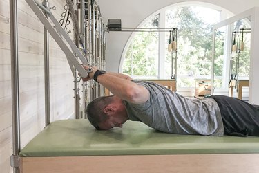 man doing babby bird pilates movement