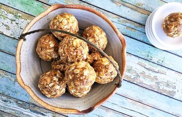 Granola Breakfast Protein Balls in a bowl on wooden table