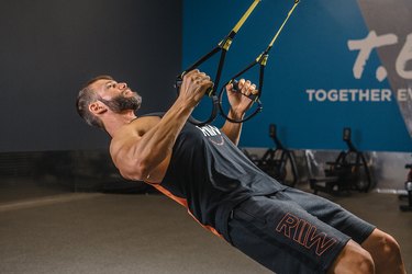 Man demonstrating how to do TRX Inverted Rows