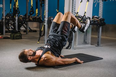 Man demonstrating how to do TRX Hip Raises