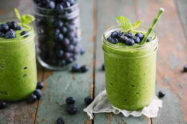 Green smoothie with blueberries on top for healthy smoothie recipe