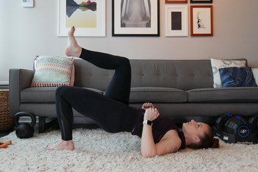 Woman demonstrating how to do a single-leg glute bridge