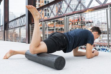 man demonstrating foam rolling hip flexor and quad