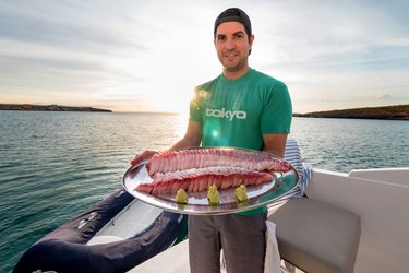 Omega Blue co-founder and executive chef  Cody Requejo with a platter of Baja Kanpachi sashimi.