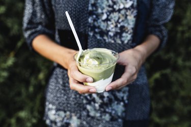 Woman holding avocado ice cream