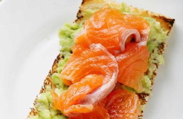 an overhead photo of a blue zone-inspired breakfast recipe of Smoked Salmon Avocado Toast on a white background