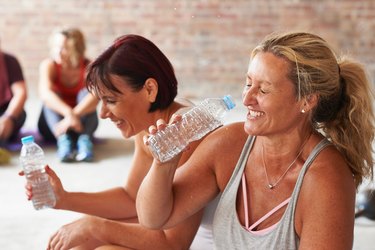 two middle-aged women laughing after cardio workout