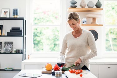 Woman in her 40s preparing low-carb dinner in her kitchen