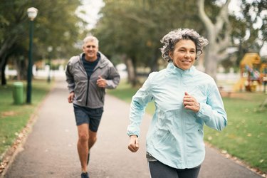 Woman and man who may want to get a flat stomach jogging outside