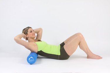 woman lying on foam roller under shoulder blades for Rehydrate technique of the MELT Method