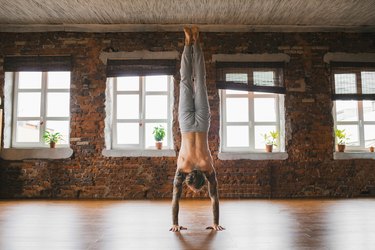 Man doing handstand yoga pose for balance