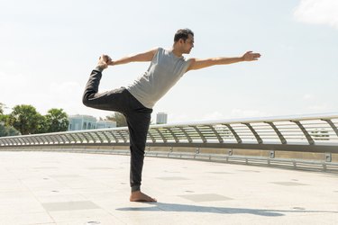 Man doing Lord of the Dance standing yoga pose for balance