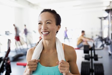 Woman happy and confident working hard in gym