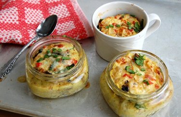 蘑菇、菠菜和焦糖洋葱煎蛋卷装在罐子里，配上勺子和红色餐巾
