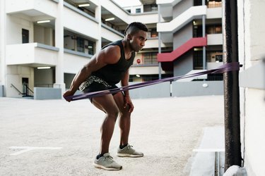 Man using long-loop resistance band.