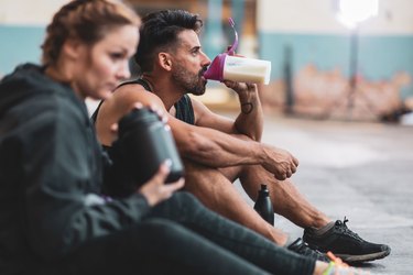 Athletes drinking amino acid supplements