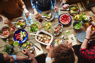 Top view of friends eating dinner around the table