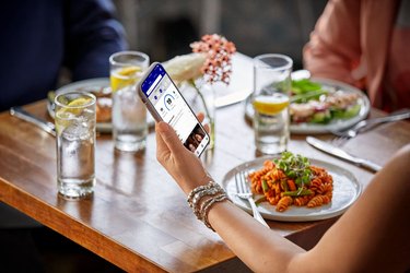 people sitting around table eating dinner