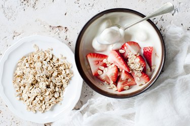 Eating raw oats in yogurt with strawberries