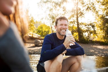 man smiling and drinking water perineal muscle exercises