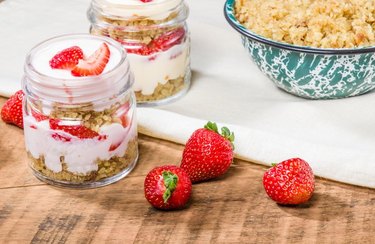 jars of overnight oats with strawberries on wooden surface