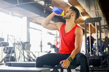 Young man drinking protein shake after workout to help lose weight