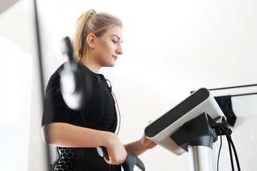 Woman using device for electromagnetic weight loss