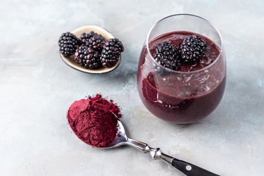 Berry Smoothie with spoon full of vegan protein powder