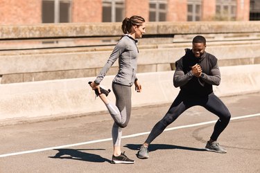 Runners stretching outside in urban area before or after a race