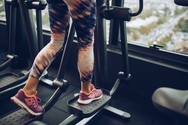 person on an elliptical machine wearing colorful leggings