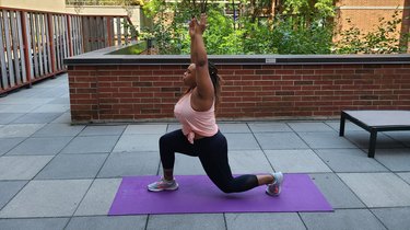 Woman doing split squat pulses as part of a unilateral mobility workout