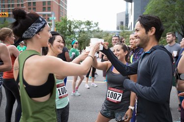 Group of friends cheersing with water after a marathon