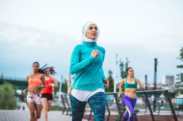 Women in running group training for an 8K run